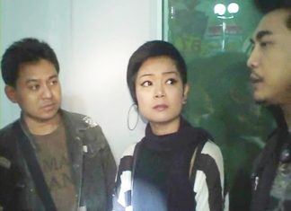 Janthima Limsawat, center, is taken into custody on human trafficking charges.